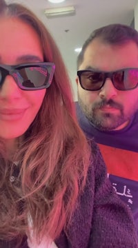 a man and woman taking a selfie in sunglasses