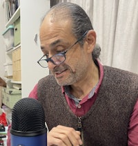 a man sitting in front of a microphone